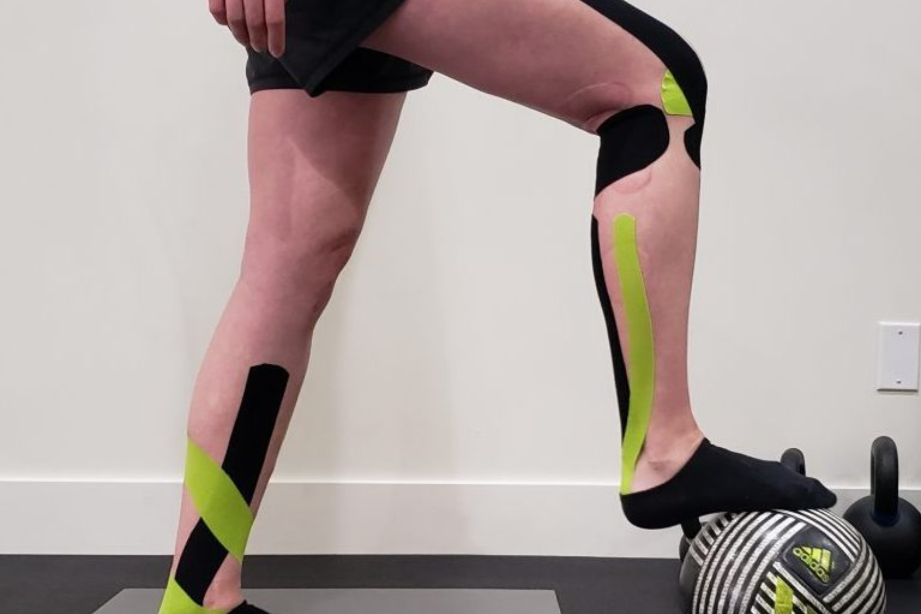 Athlete's legs with electrical tapes