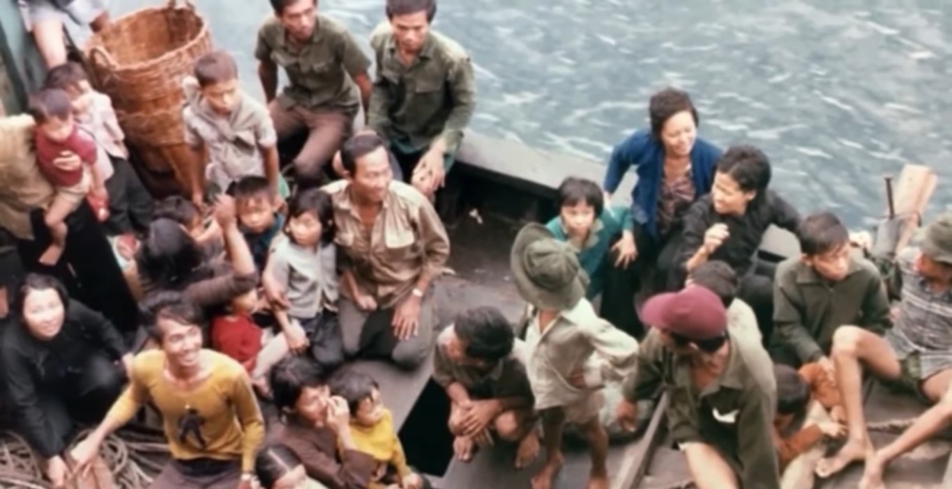 Male and female boat people both adults and children from Vietnam traveling aboard a boat
