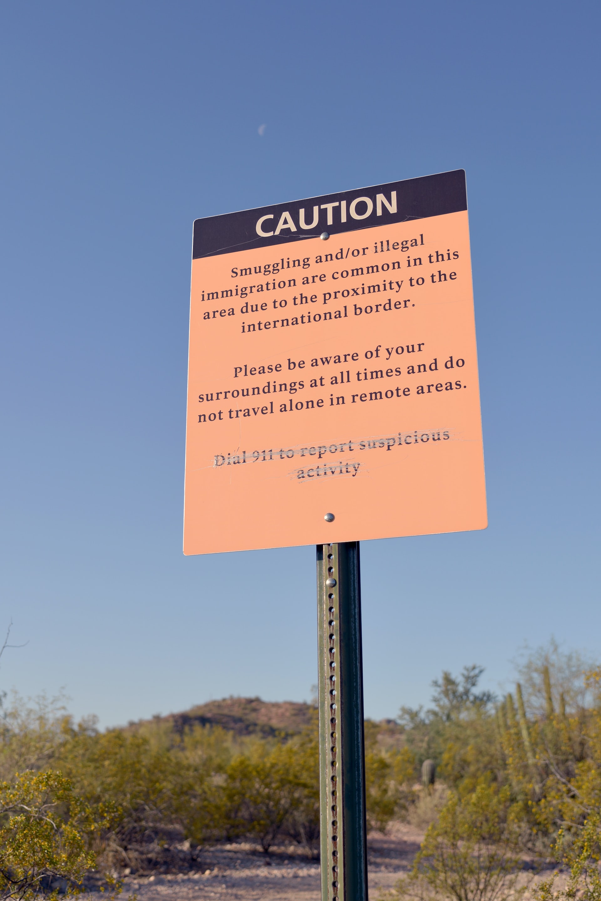 A tall sign post about smuggling and illegal immigration at Organ Pipe Cactus National Monument, Arizona, USA 