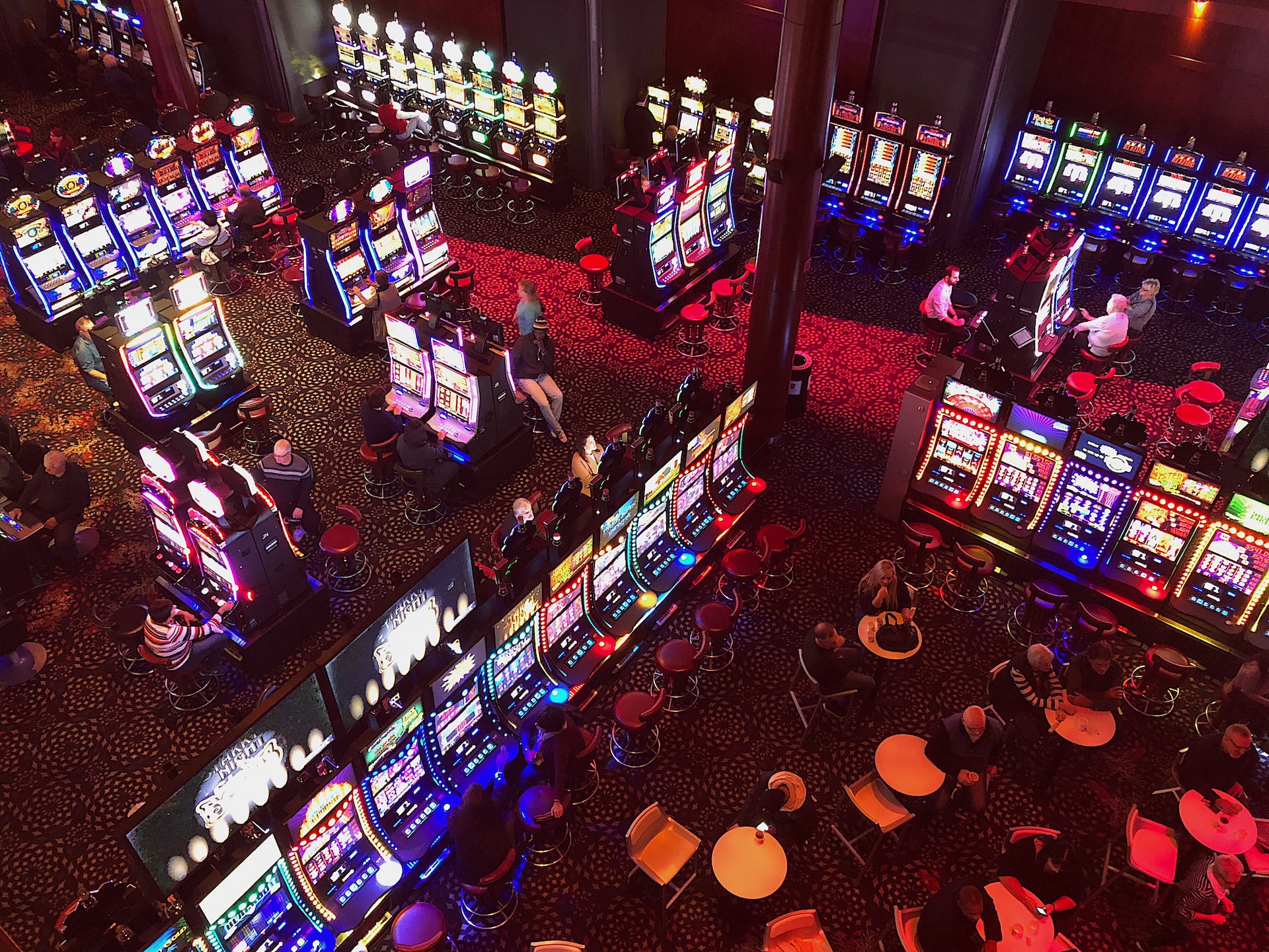A sky view of several people playing slot machine games in a casino