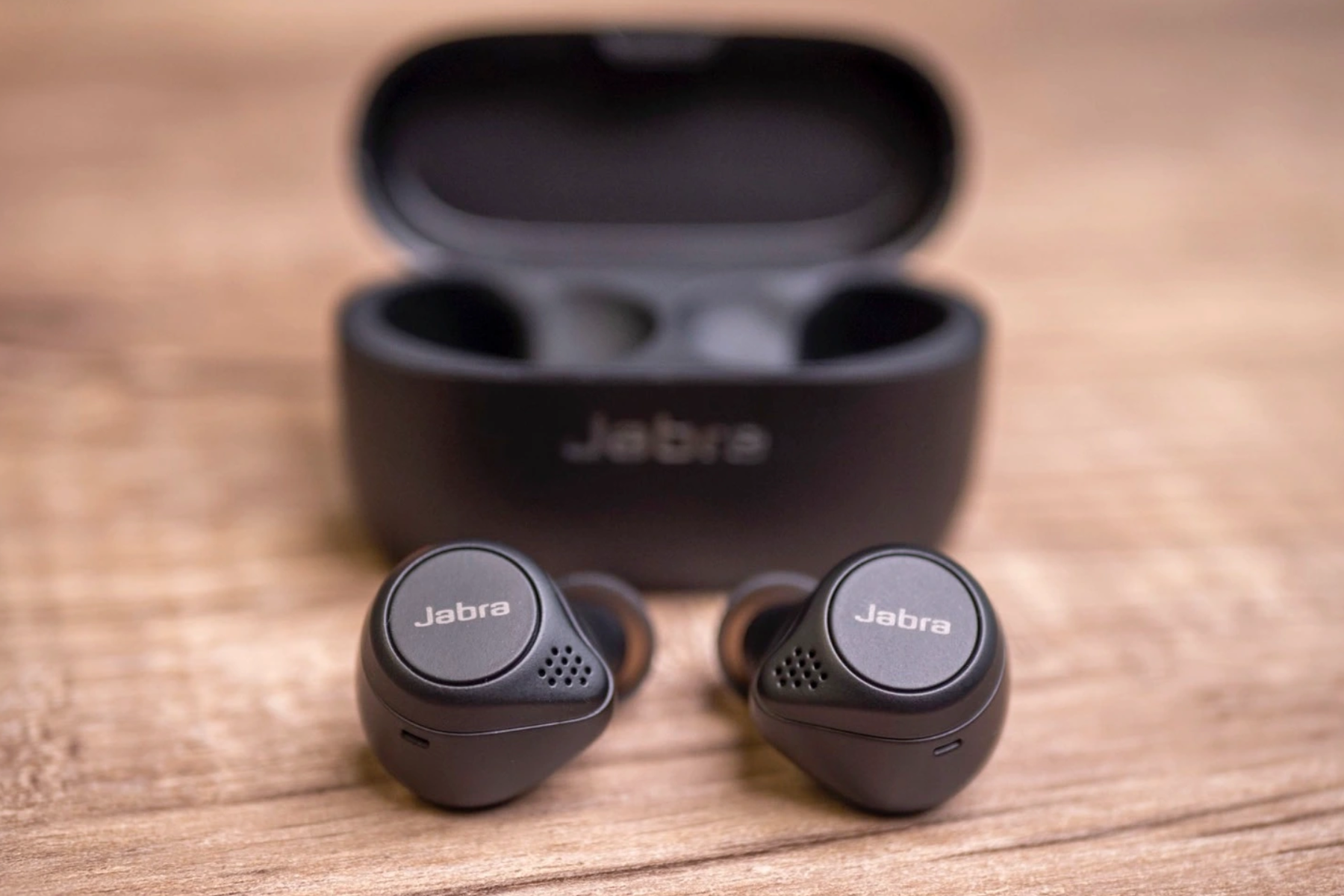 A Jabra Elite 75t Earbuds outside its charging station