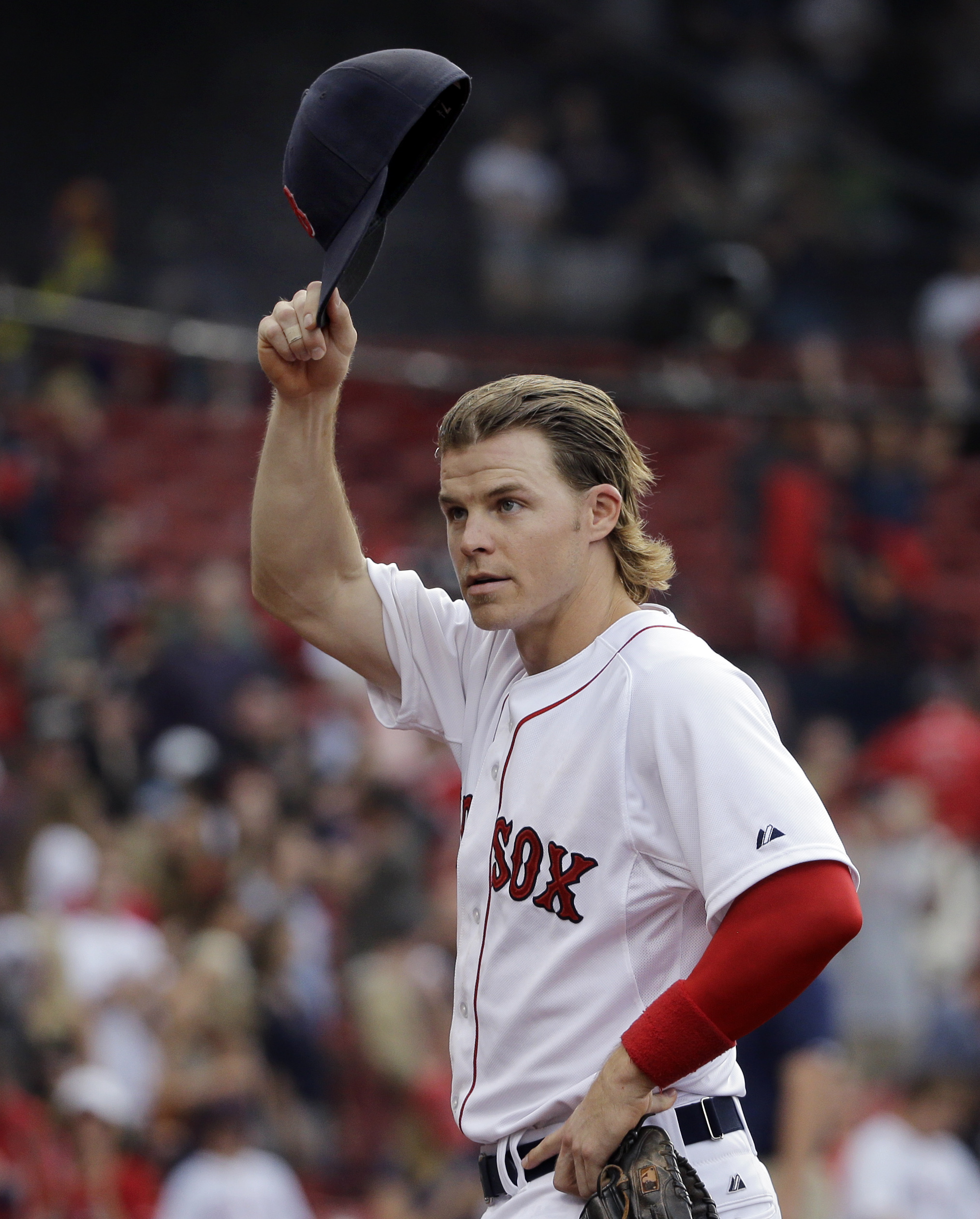 Brock Holt in his white and red Boston uniform while taking his cap off