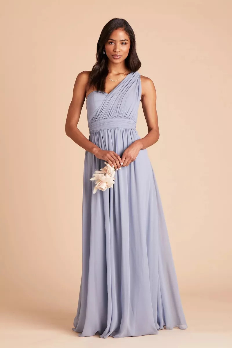 A Bridesmaid Wearing A Birdy Dusty Blue Chiffon Dress And Holding A Flower