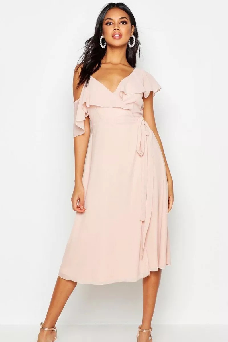 A Bridesmaid Wearing A Boohoo Peach Cold Shoulder Wrap Midi Dress With White Earrings