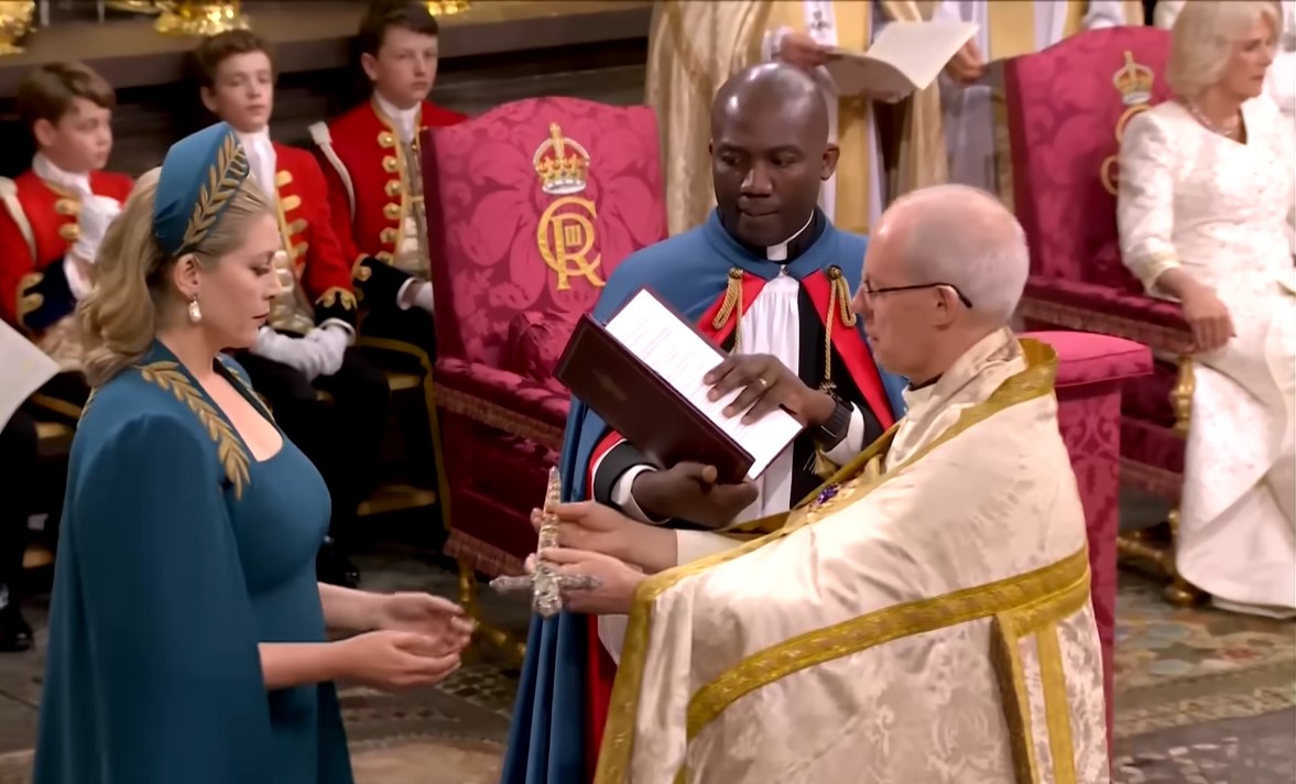 Penny Mordaunt lays out her hands to receive the Sword of Offering held by the Archbishop of Canterbury