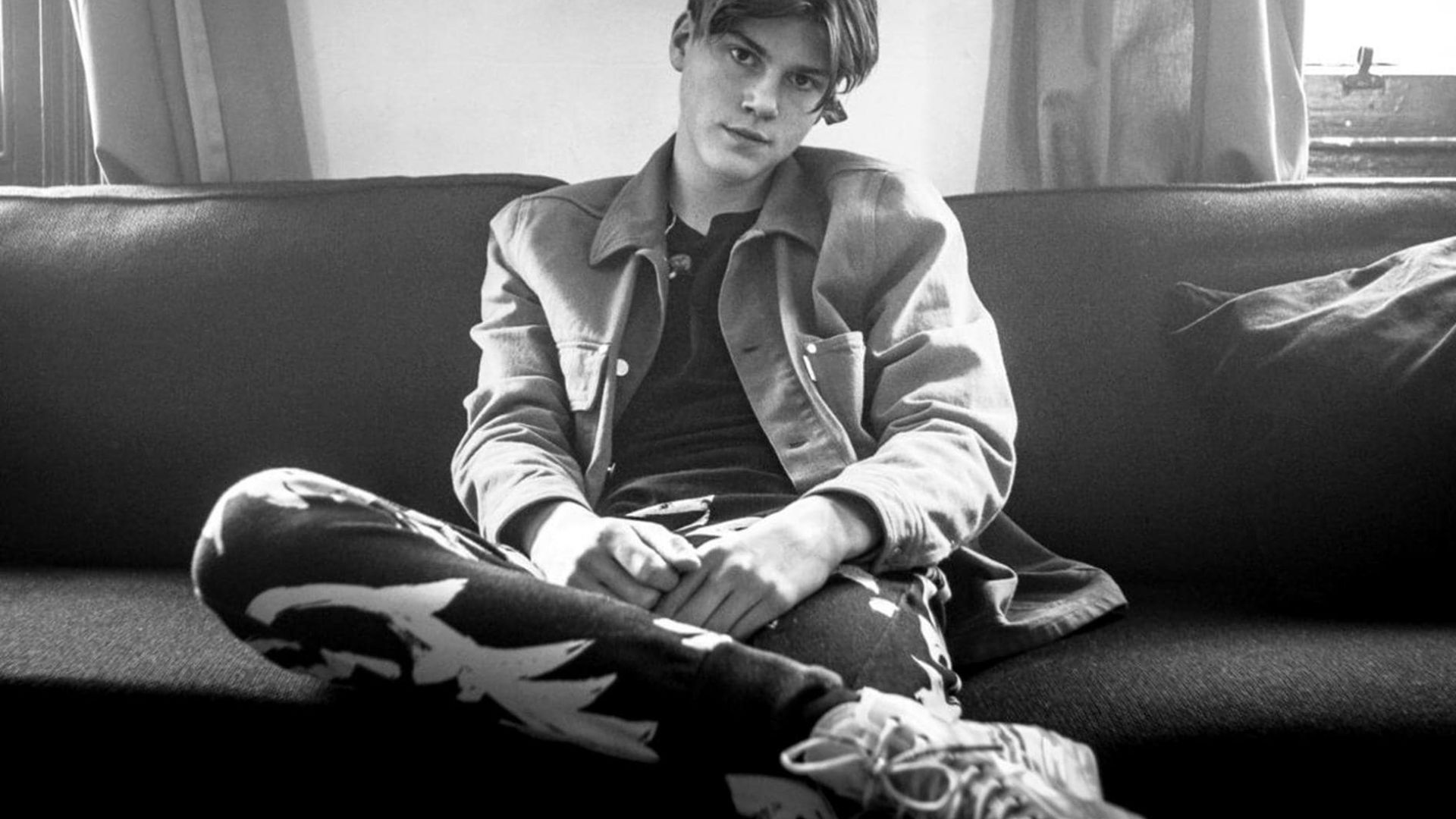 Ruel Black And White Shot Sitting On A Couch