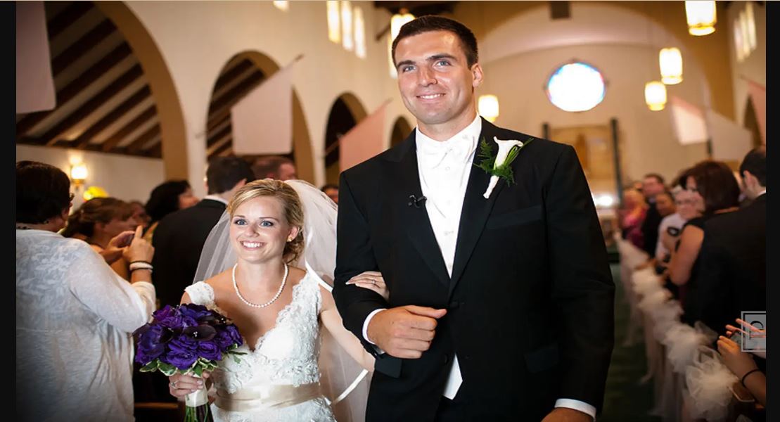Joe Flacco and Dana Grady during their wedding with big smiles