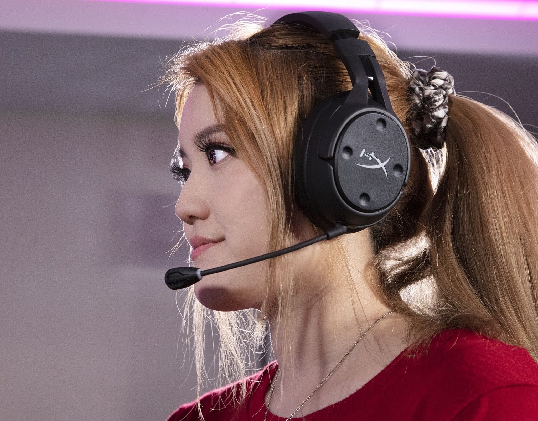 A lady wearing the HyperX Cloud Flight S headset with a black microphone