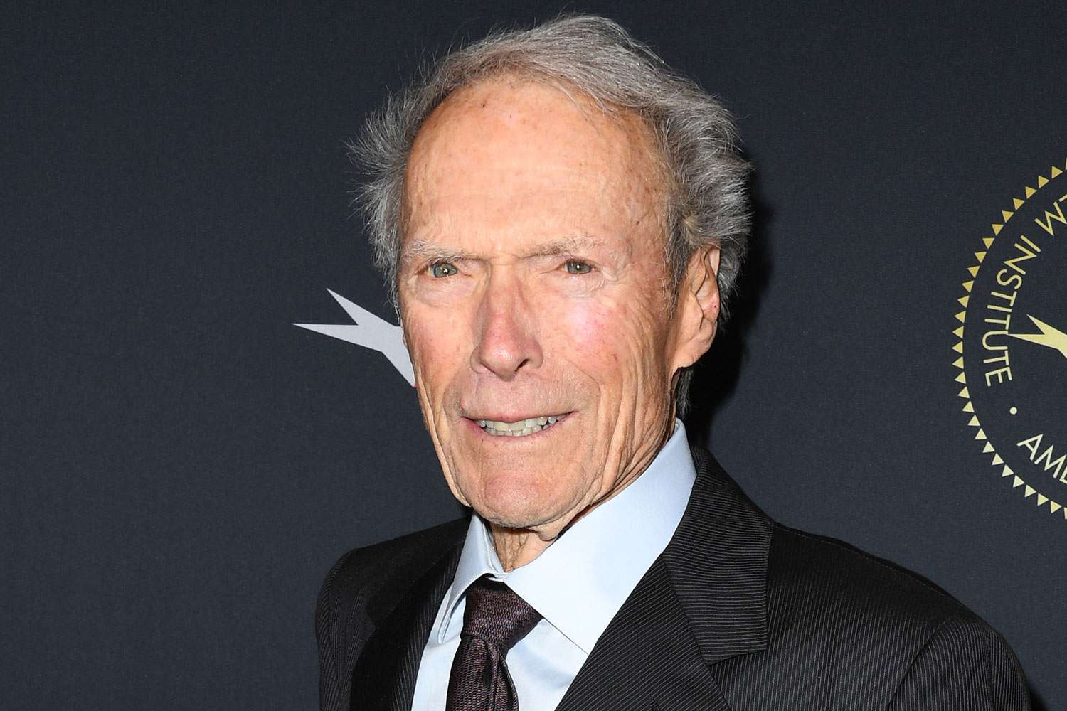 Clint Eastwood wearing a black suit