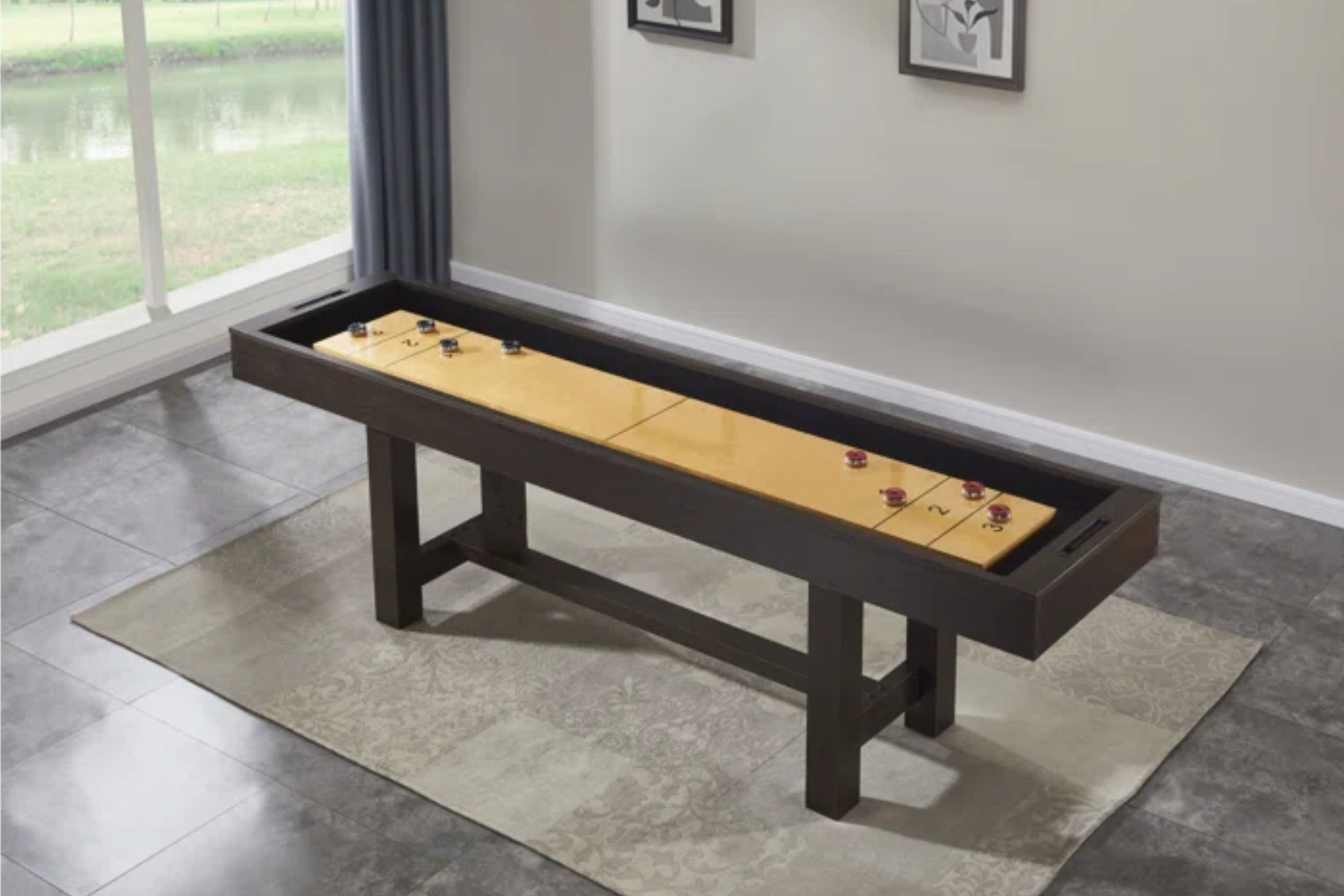 A shuffleboard table of reduced dimensions is placed inside a room