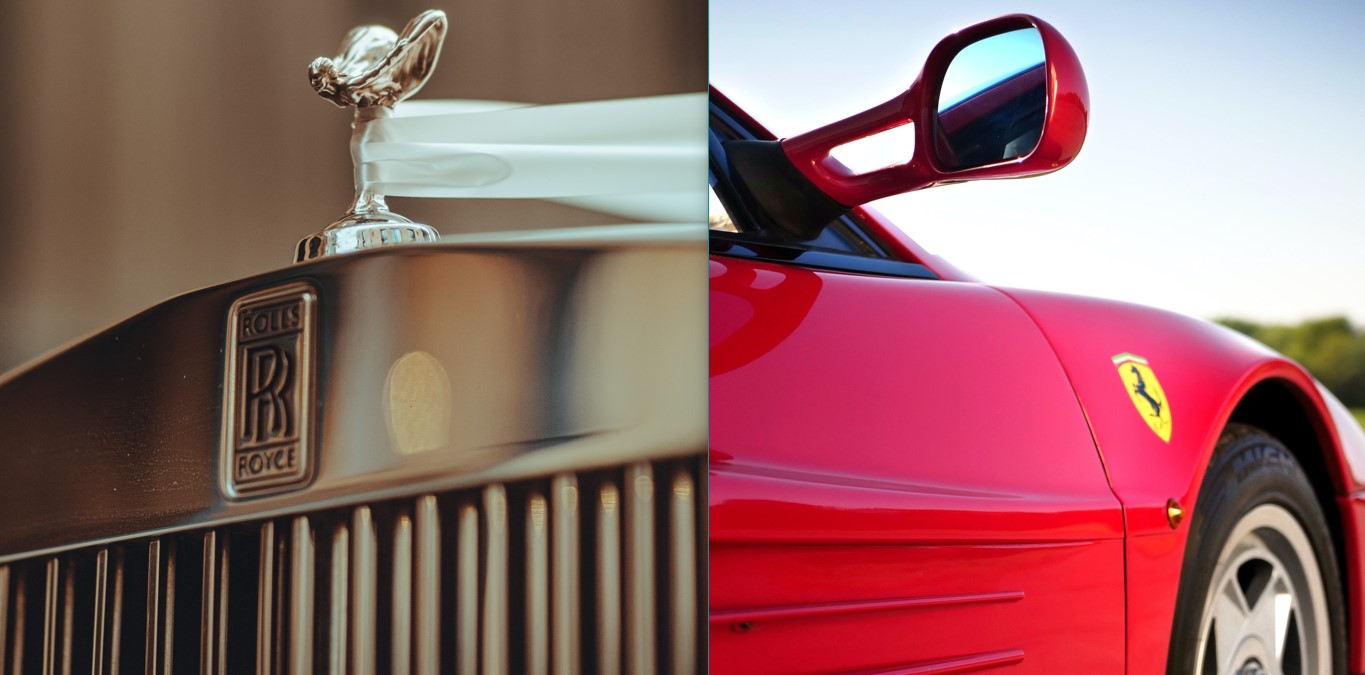Stainless-steel hood of Rolls-Royce, with a hood ornament of a woman leaning forwards; a red Ferrari’s nearside