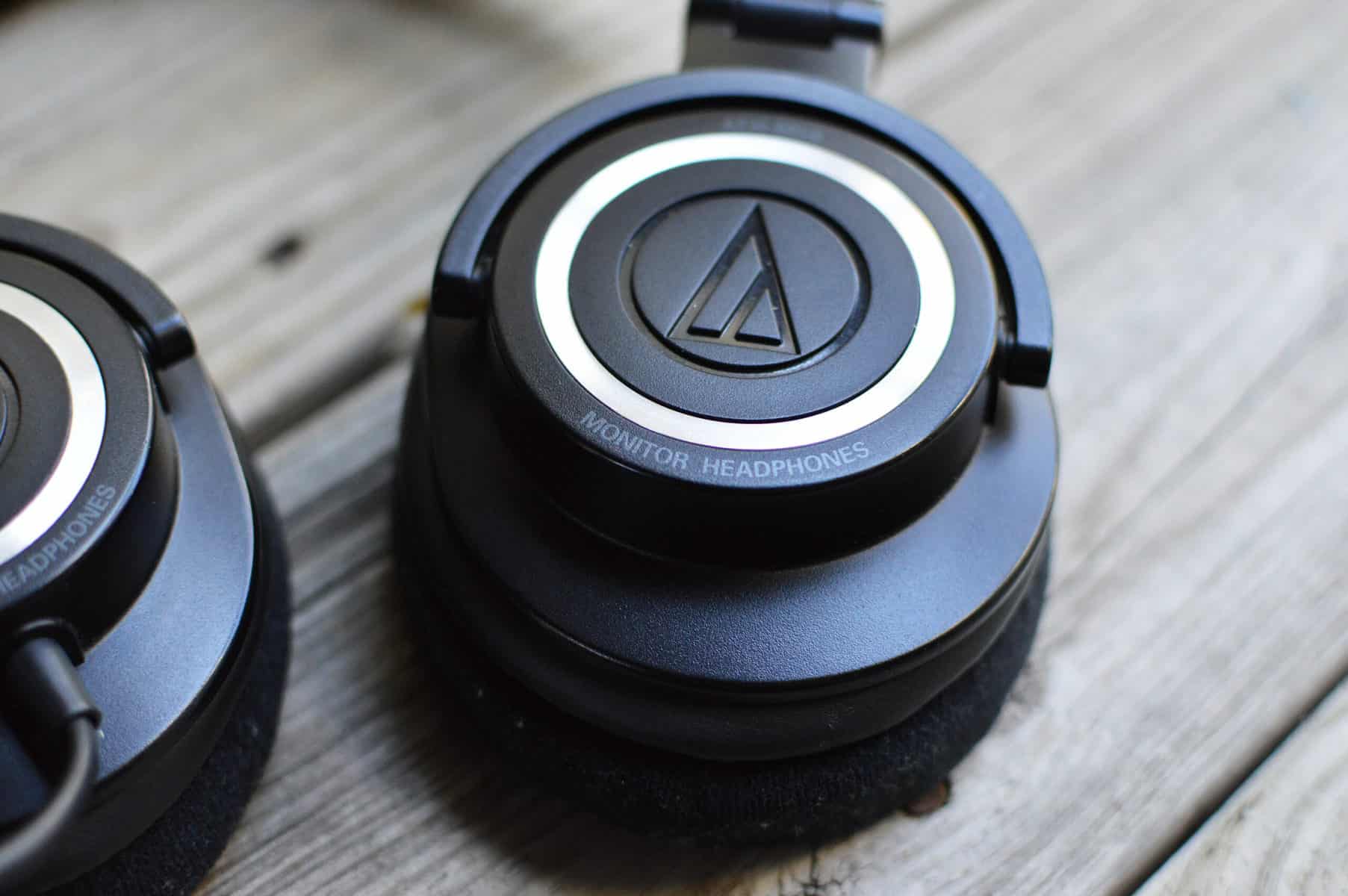 The Audio-Technica ATH-M50x headset sitting on a wooden platform