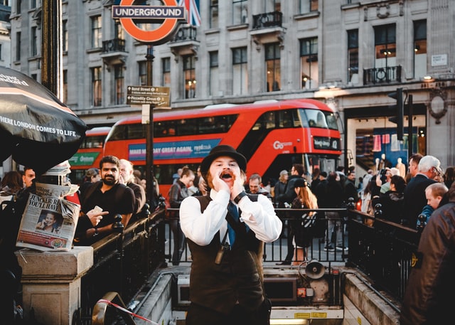 Male Londoner wearing black hat shouting at Oxford Street in London