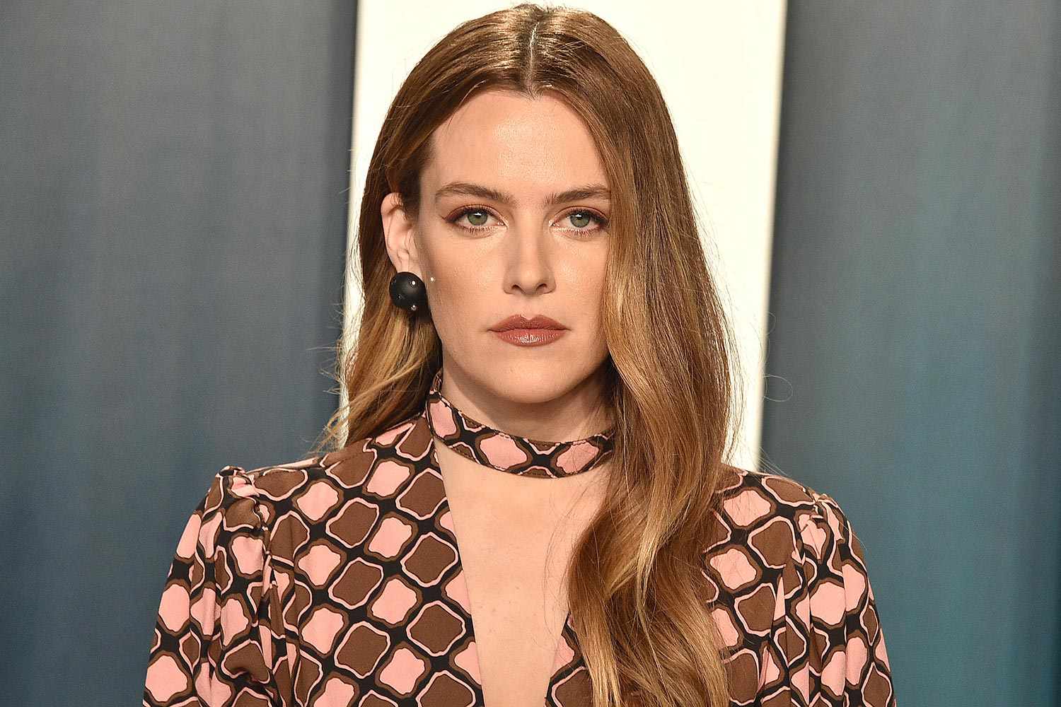 Riley Keough wearing a pink and brown coat