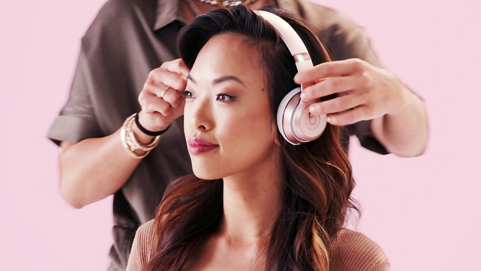 A girl with long hair wearing headphones