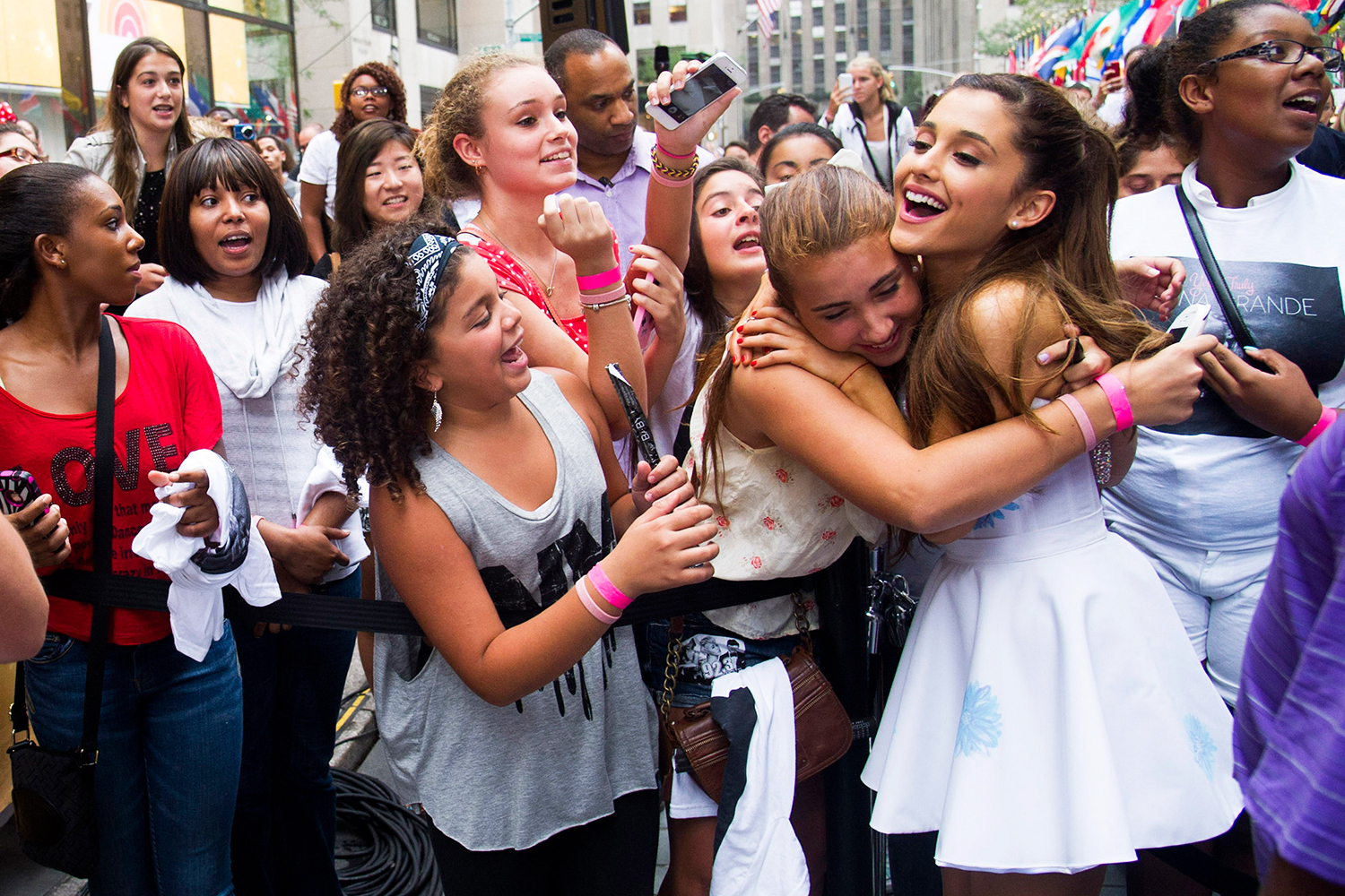Ariana Grande hugging her fans off stage.