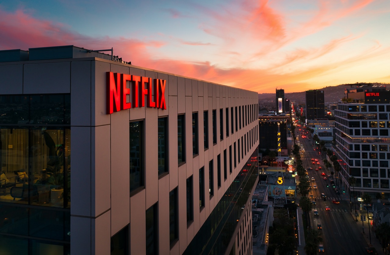 The red Netflix sign on its building at sunset in Hollywood, Los Angeles