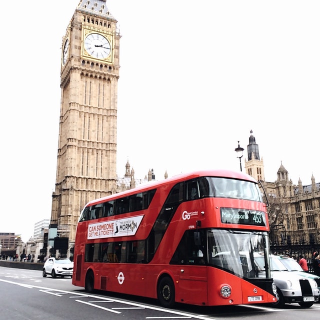 Red double-decker bus in Pavement Road in London passing by the Big Ben