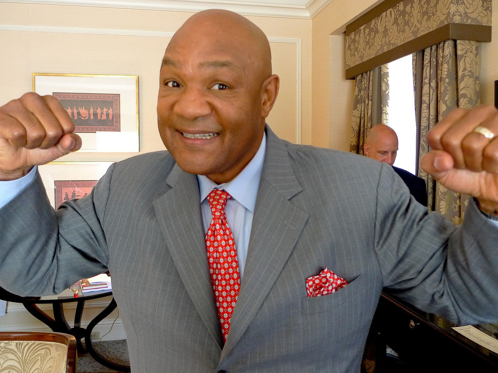 George Foreman wearing a light gray stripe suit