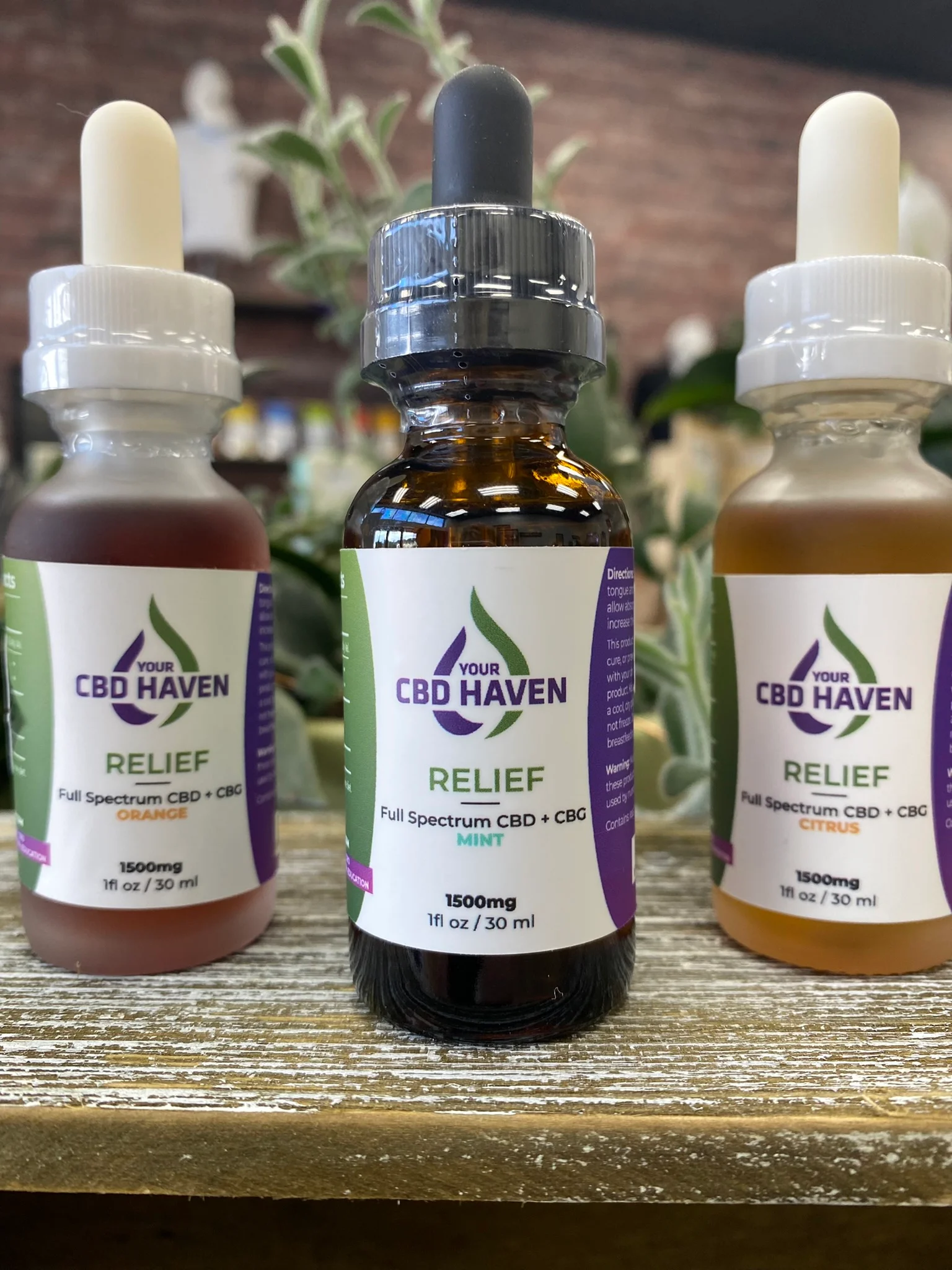  bottles of three different flavors of my cbd haven full spectrum drops on a table