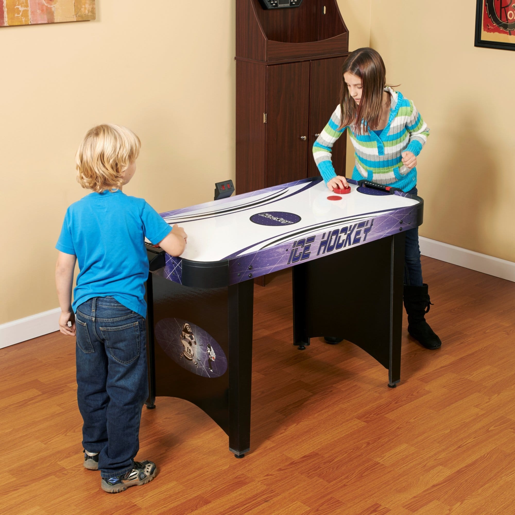 Two kids playing on Hathaway Hat Trick Air Hockey table