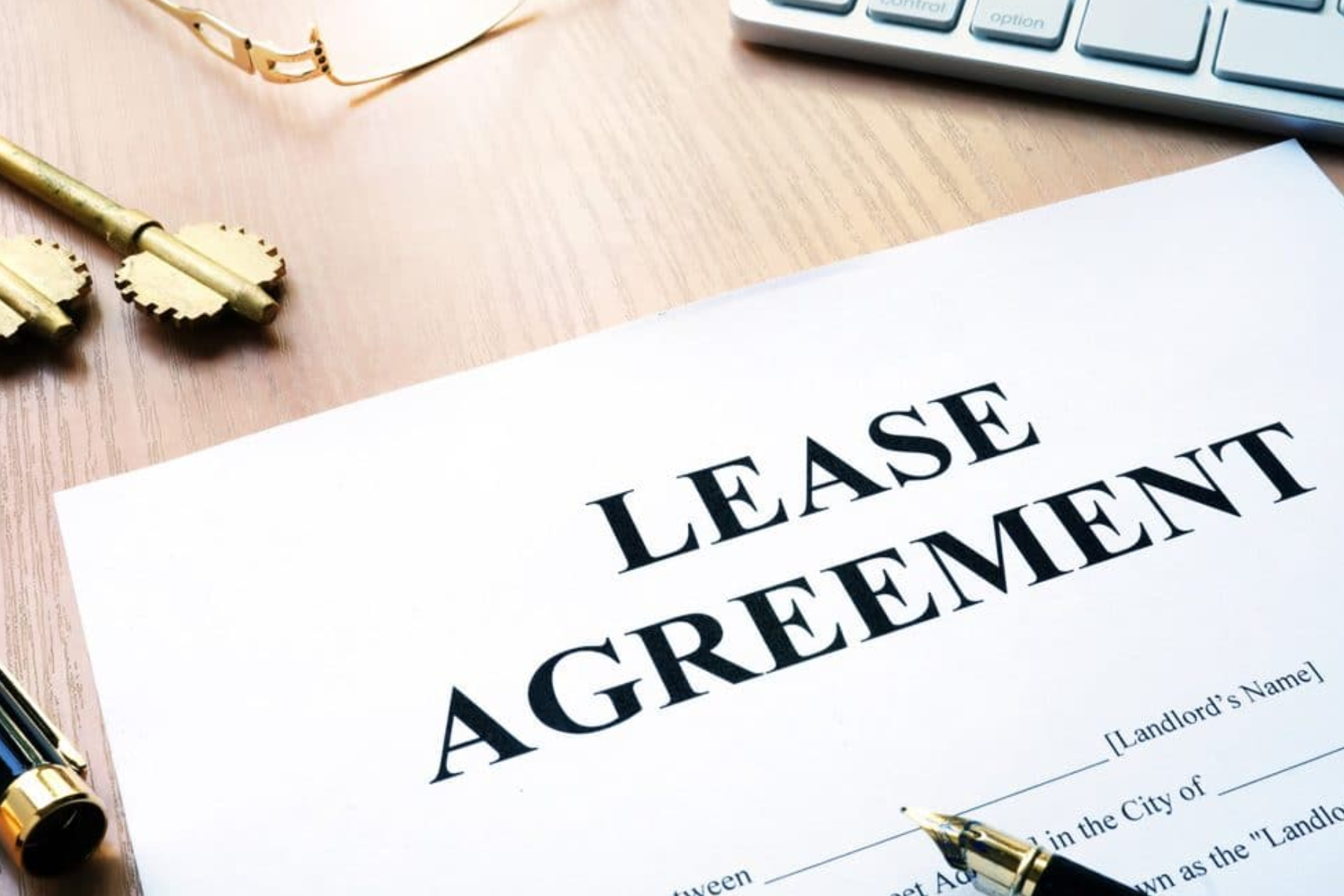 A Lease Agreement paper and the house key on a table