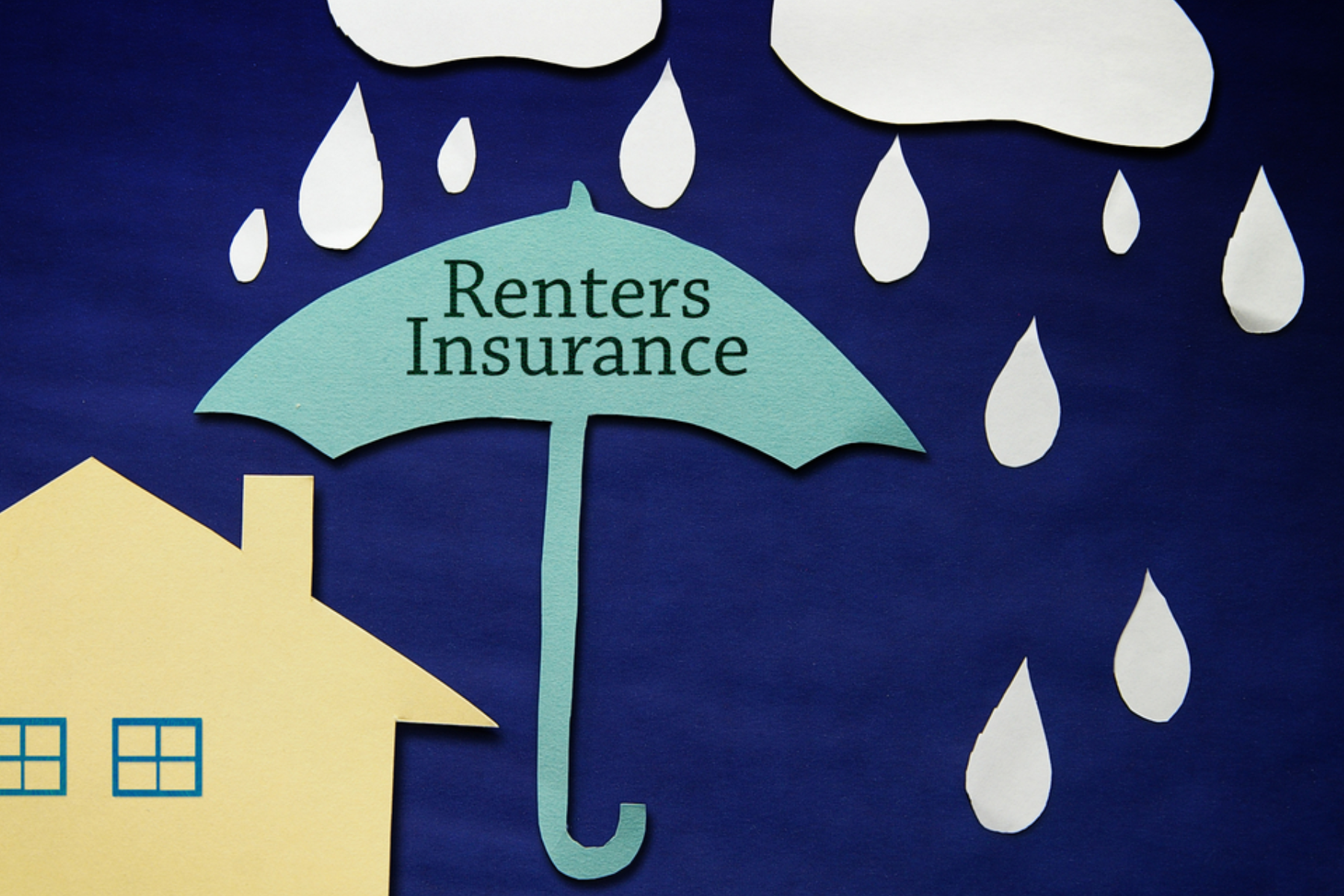 A house with a large umbrella represents the renter's insurance that protects the house from rain