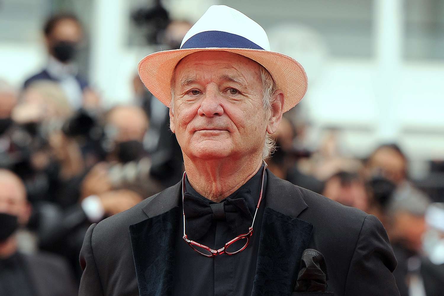 Bill Murray wearing a black suit and cap