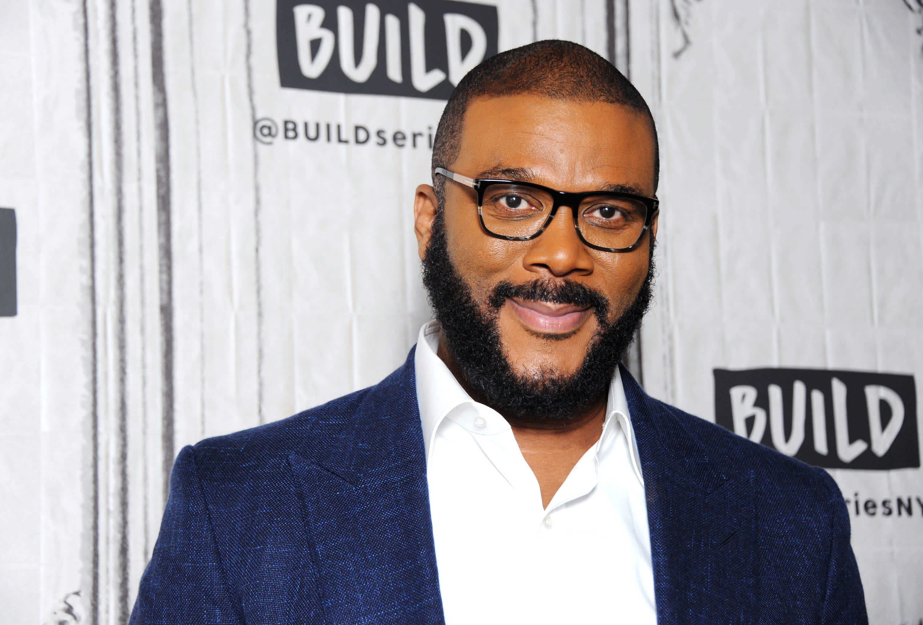 Tyler Perry wearing a blue coat