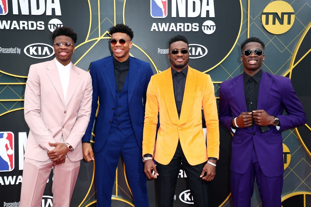 Antetokounmpo Bros wearing a different dolored coats