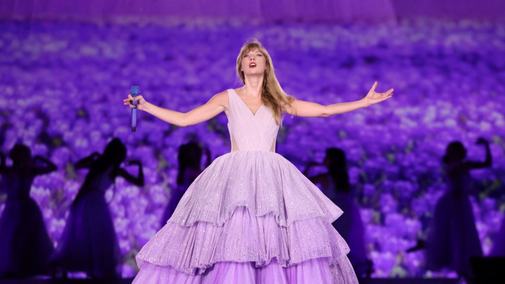 Taylor Swift wearing a purple dress