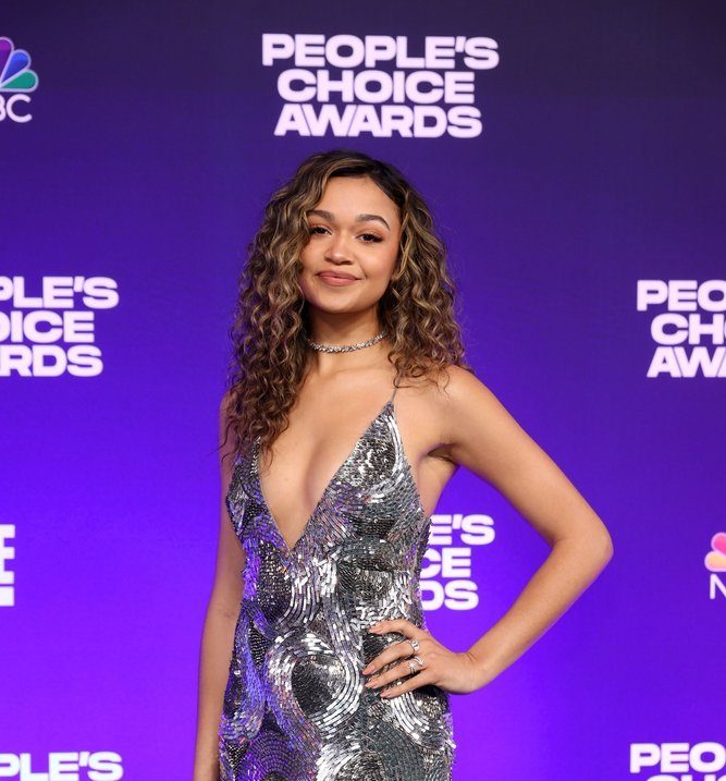 Madison Bailey wearing a revealing silver gown in the People's Choice Awards nigh