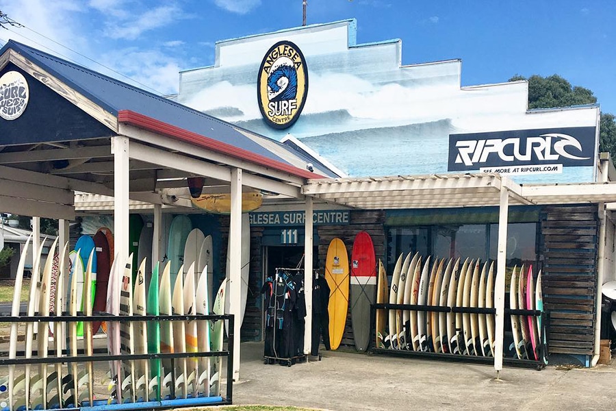 Surfboard shop with different size and colours surfboards in stands