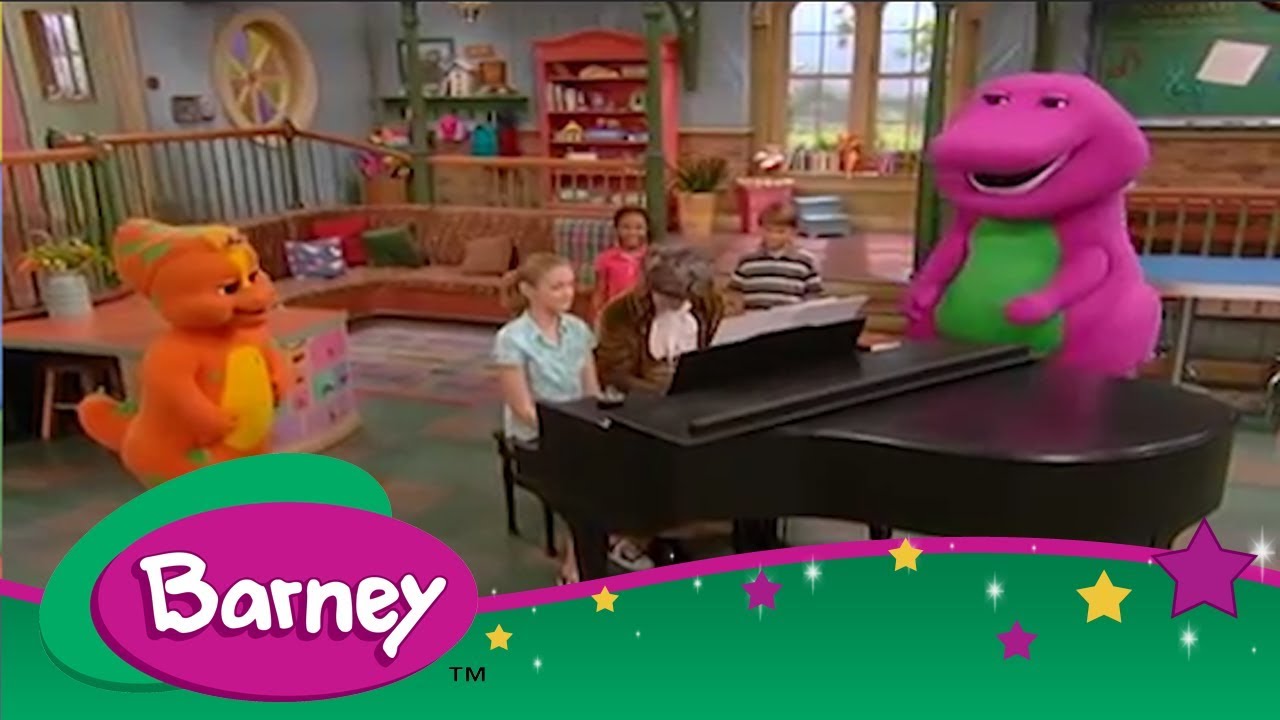Kids playing a piano with buff barney