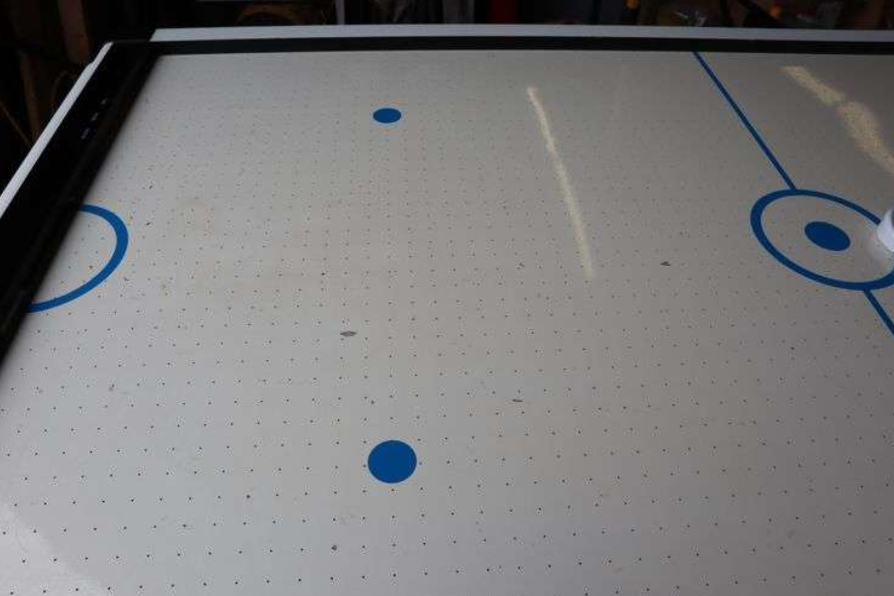 An Air Hockey Table with a damaged playing surface