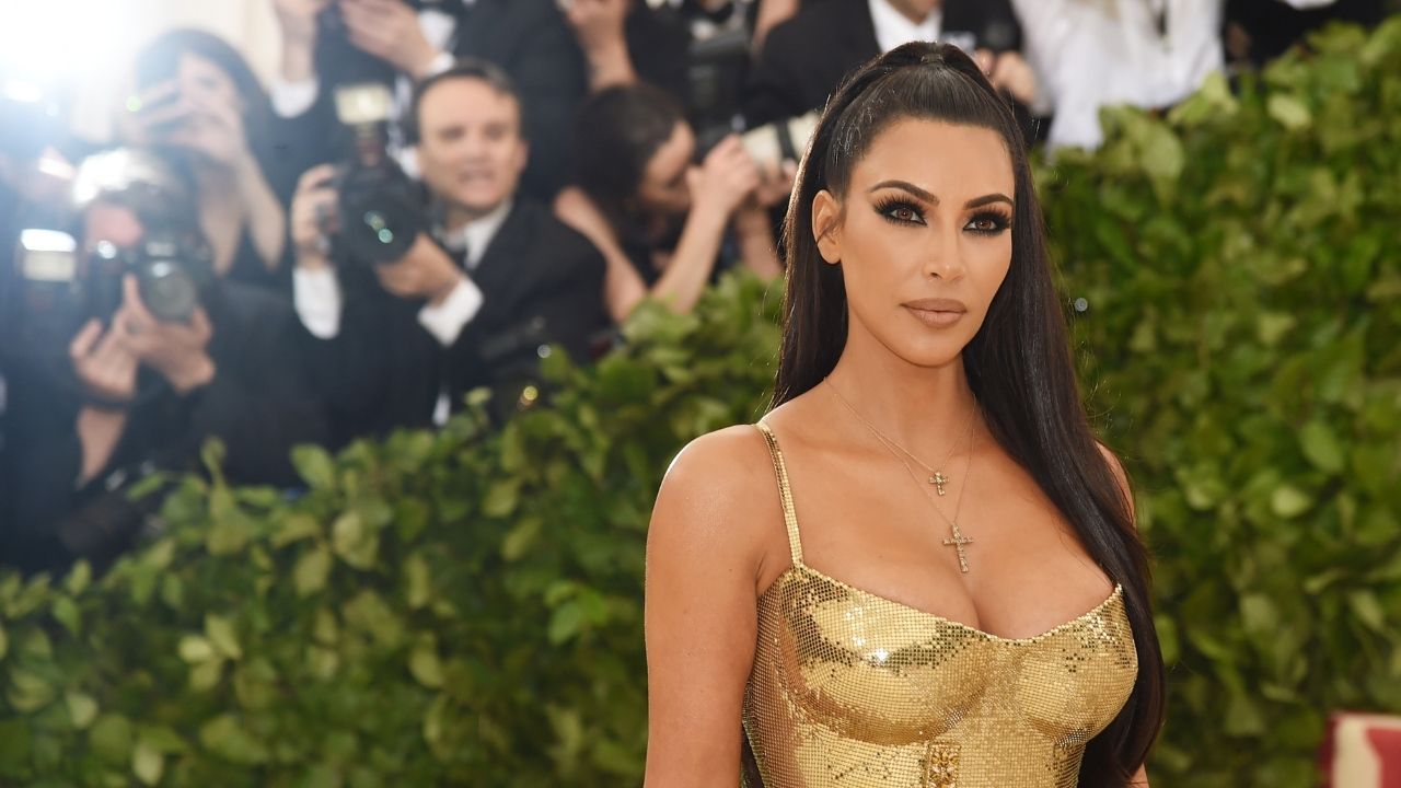 Kim Kardashian wearing a gold dress