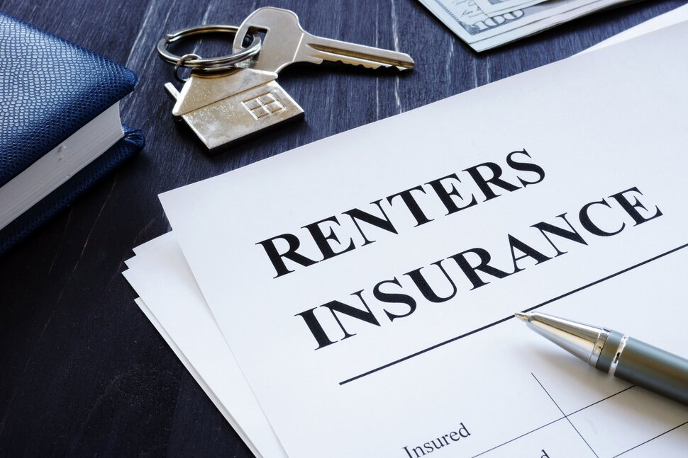 Renters insurance papers, keys and pencil