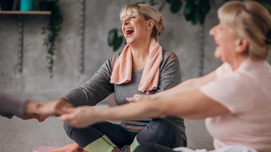 Old women sitting and practicing "Laughing Yoga"