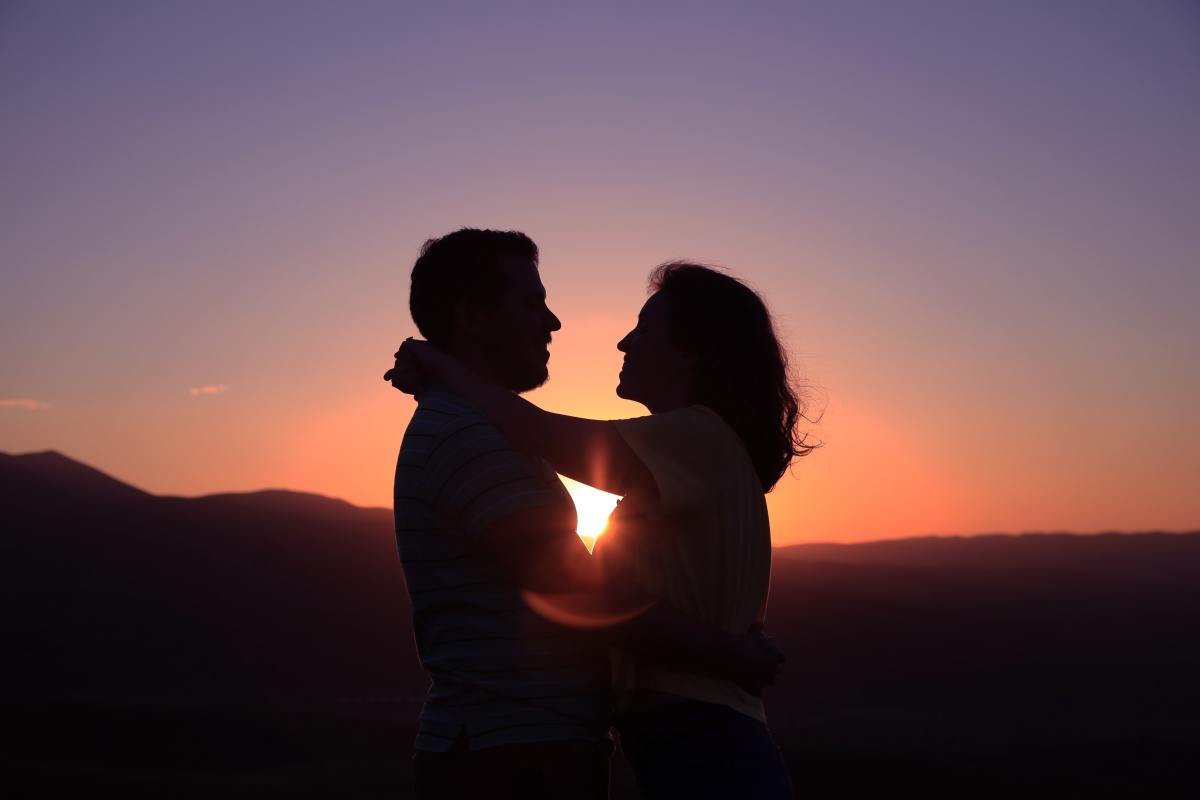 Couple hugging each other in sun set view