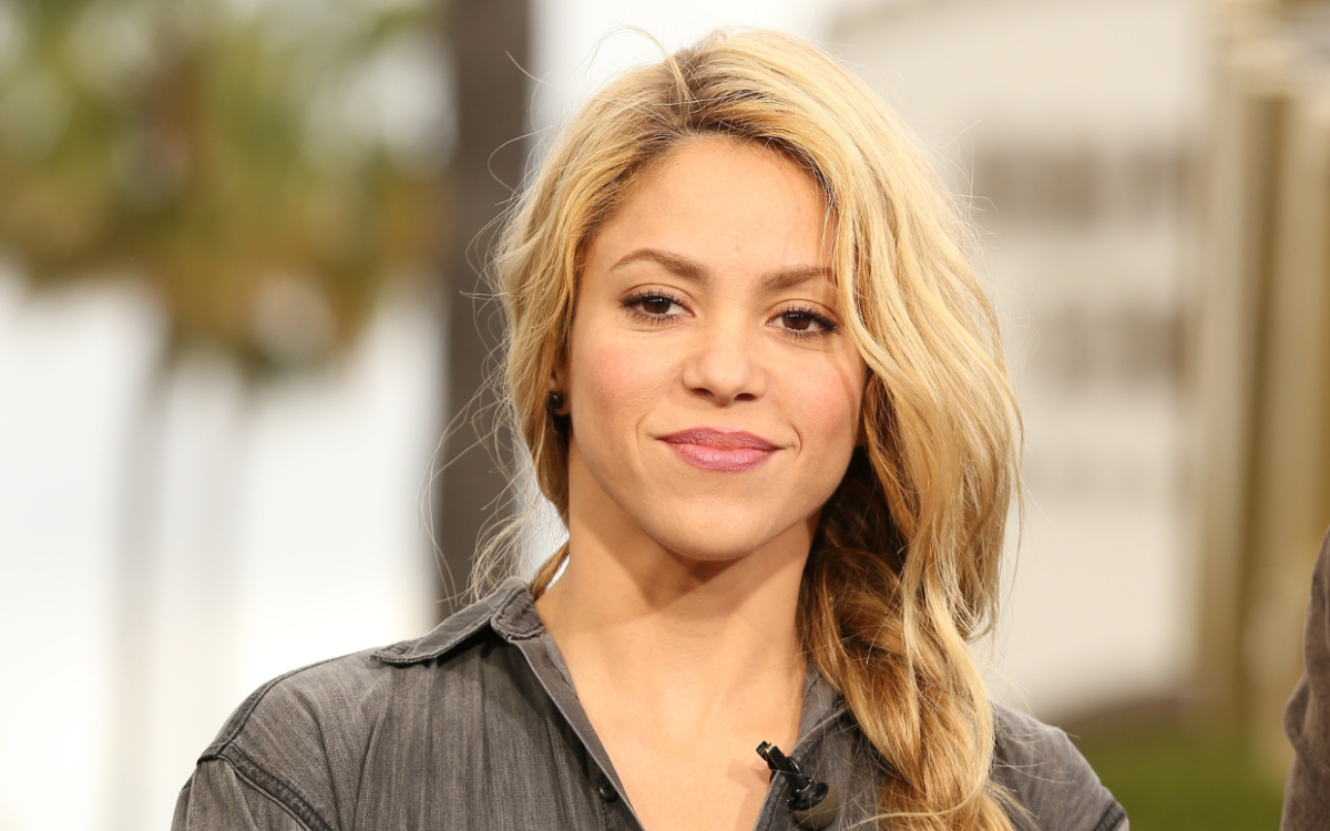 Shakira wearing a dark gray polo