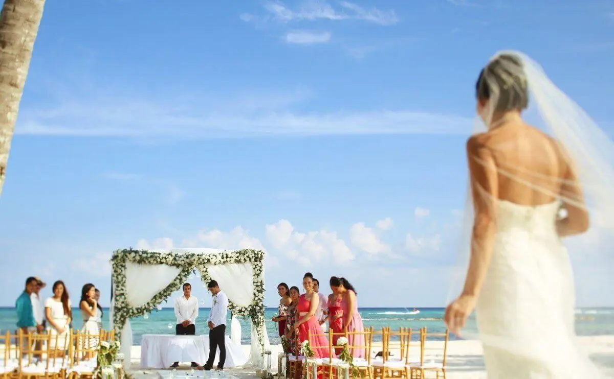 A bride and people on wedding stage at beach
