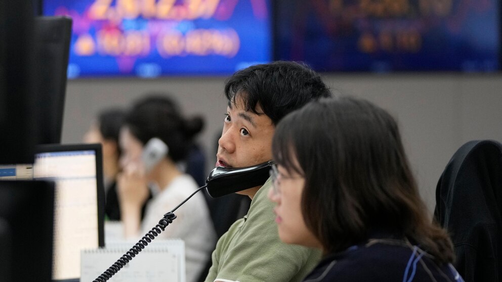 Man taking call and looking around in stock market