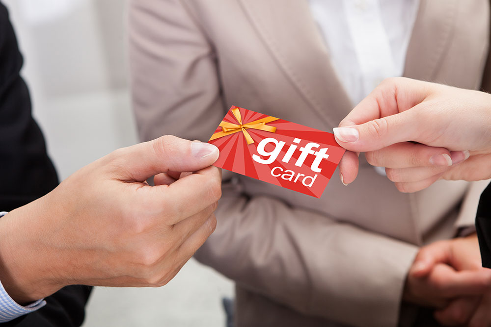 Man giving gift card to woman