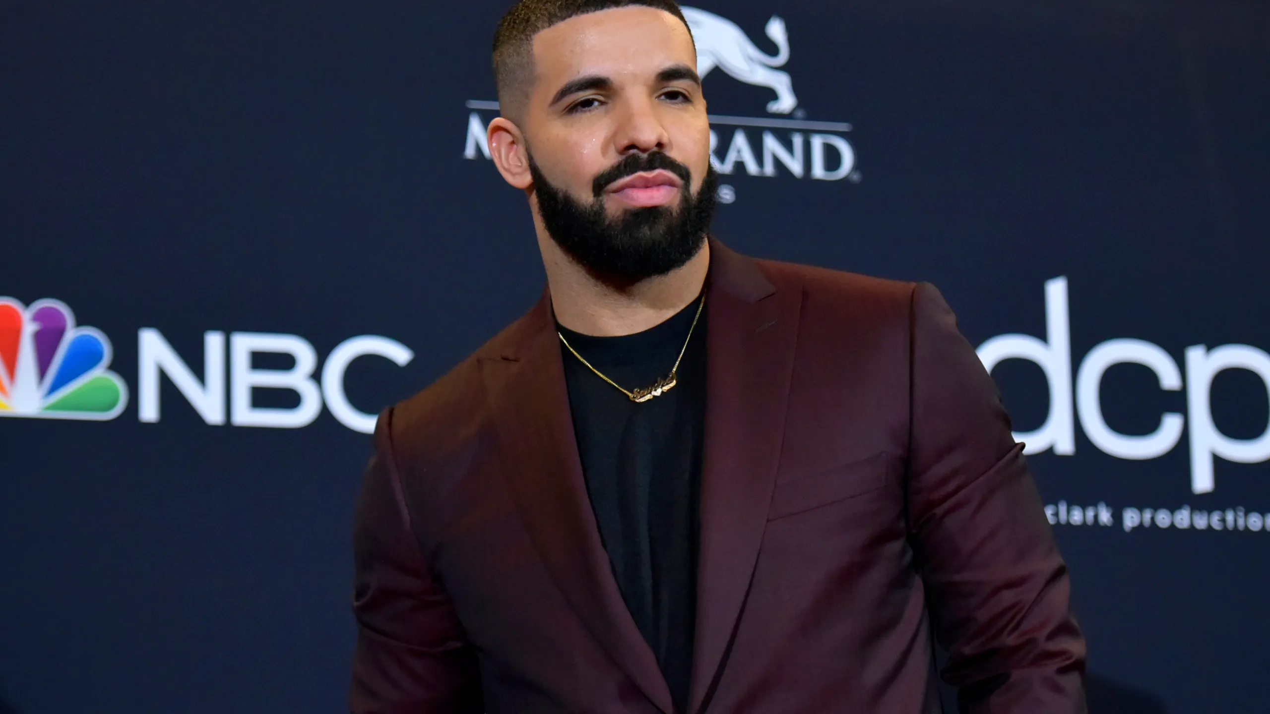 Drake wearing a burgundy suit