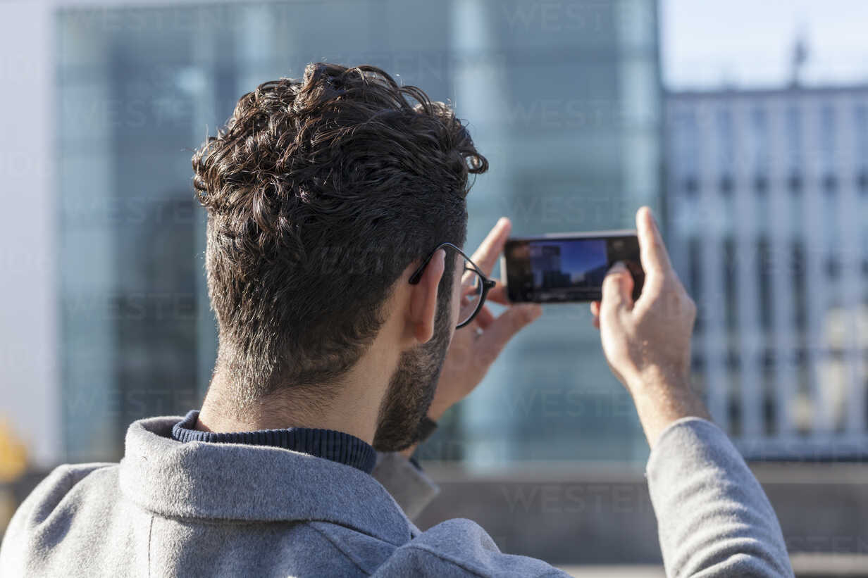 A man taking a photo using his smartphone.