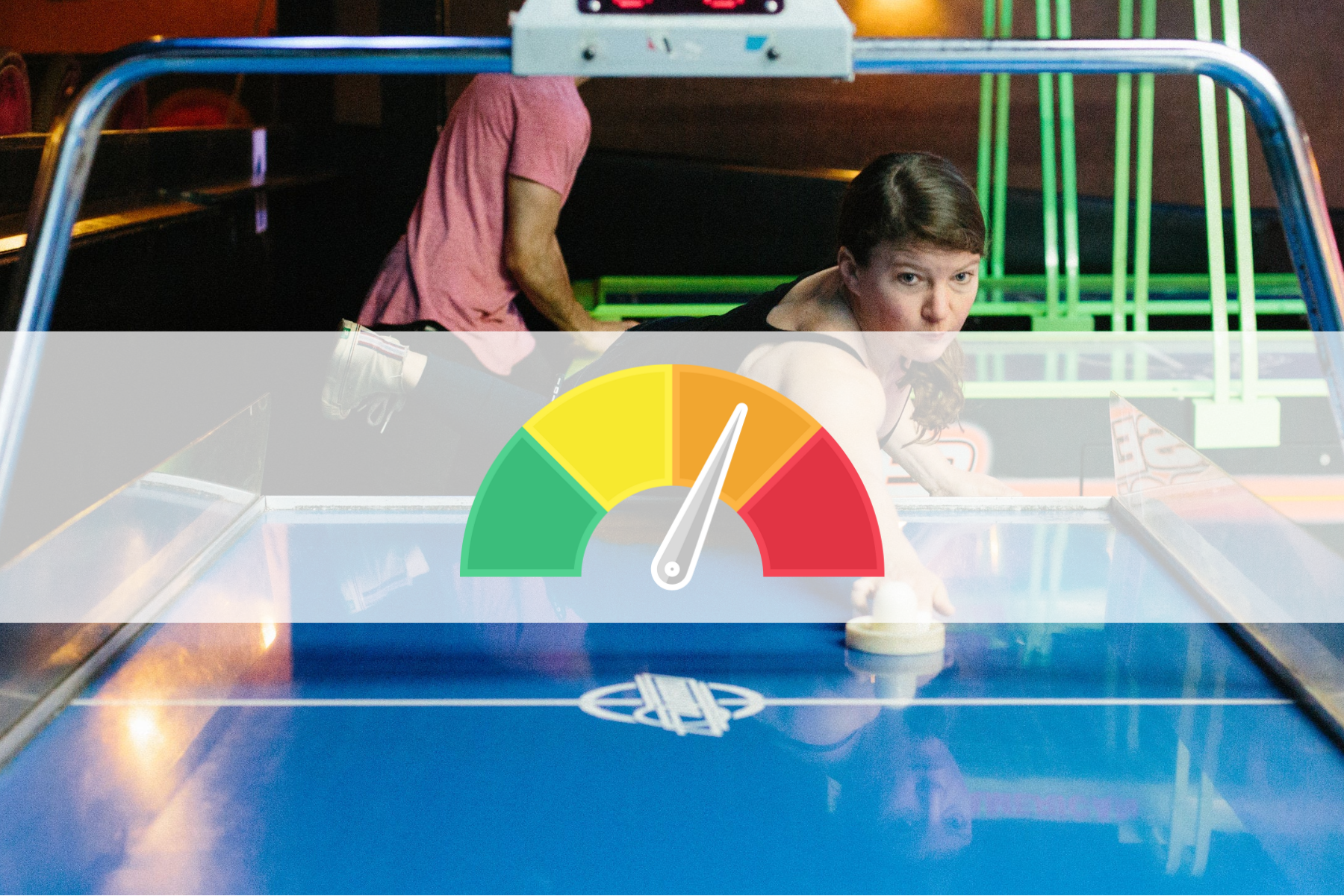 A woman engaged in a game of air hockey at a table