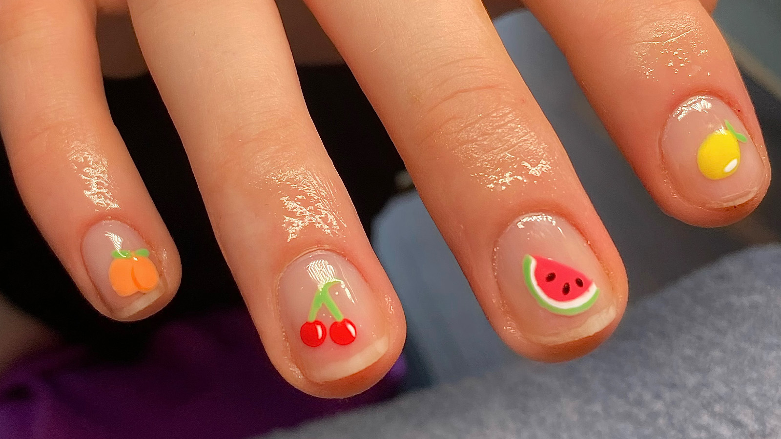 Fruit-themed nails of a woman