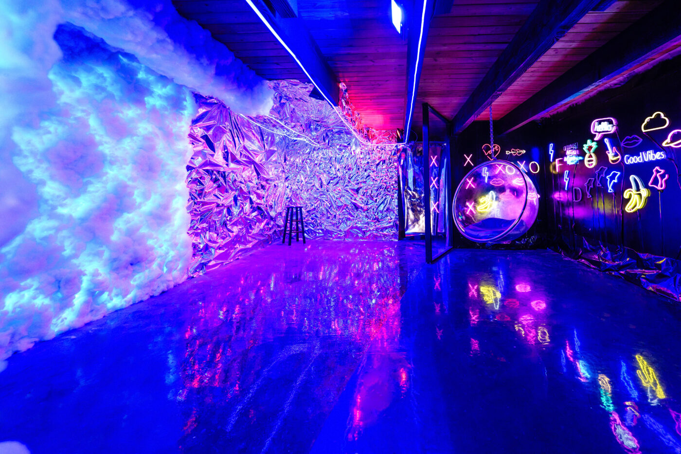 Captivating interior with a futuristic neon-lit corridor, featuring a reflective floor and eclectic neon artwork that creates a vivid and immersive atmosphere.