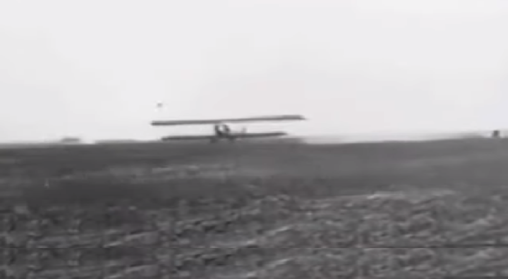 Black and white picture of helen keller flying a plane while in air