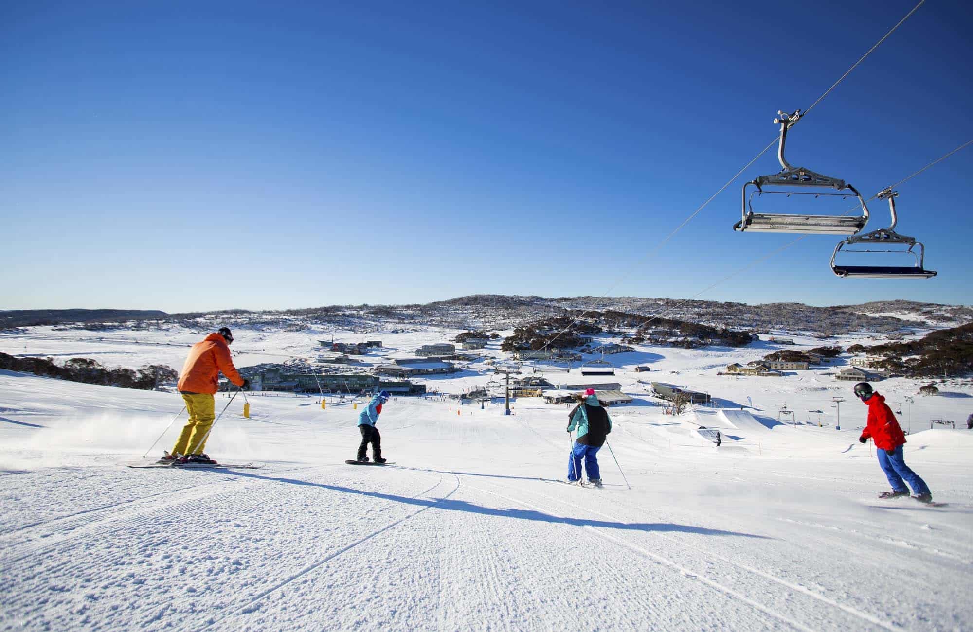 Four person skiing in snow in australia